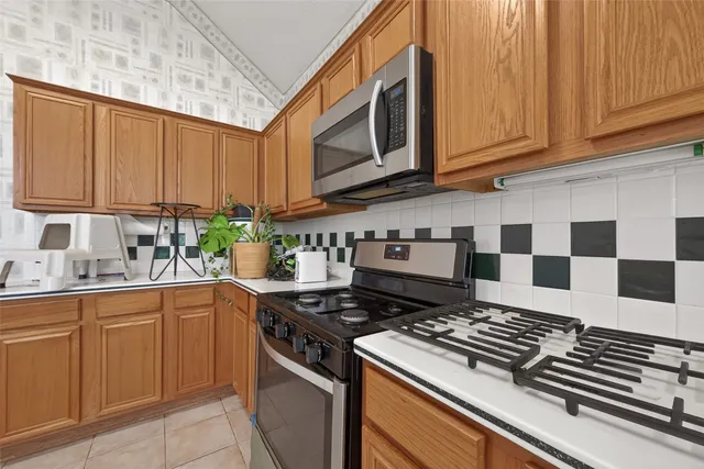 a kitchen with stainless steel appliances granite countertop a stove a sink and dishwasher