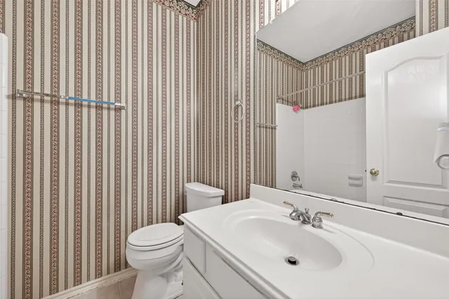 a bathroom with a sink a toilet and shower curtain