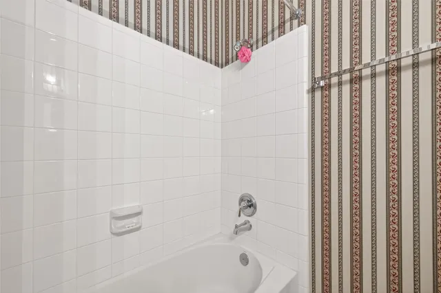 a bathroom with a white bathtub