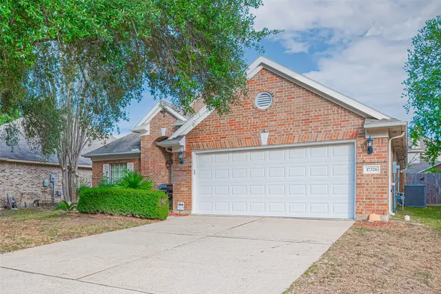 a house that has a tree in front of the house