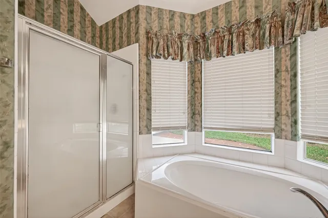 a bathroom with a bathtub and window