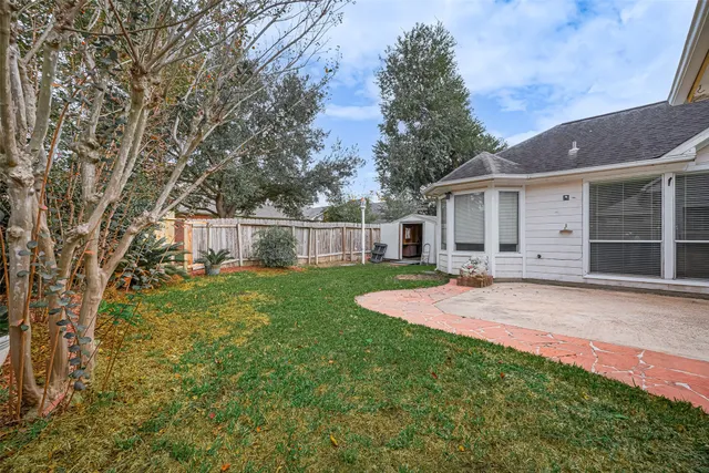 a front view of a house with yard and green space