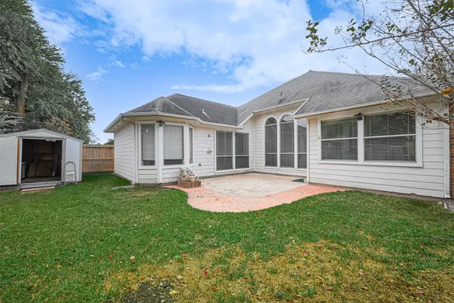 a front view of a house with yard and green space
