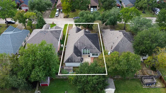 an aerial view of house with a yard