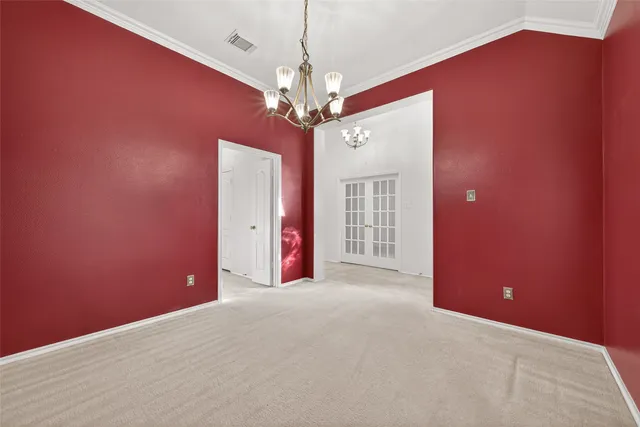 a view of a livingroom with a chandelier fan and windows