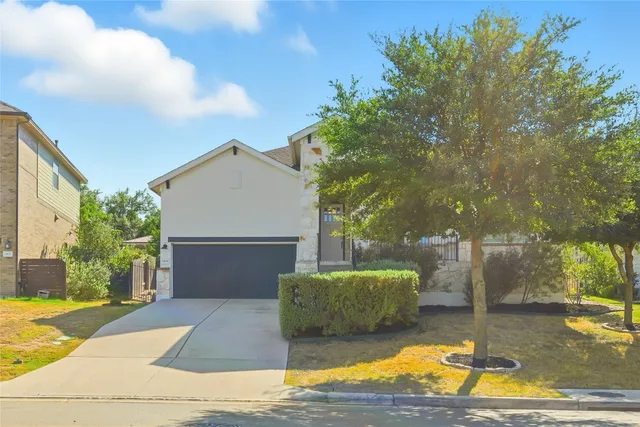 a view of a patio with table and chairs potted plants and large tree