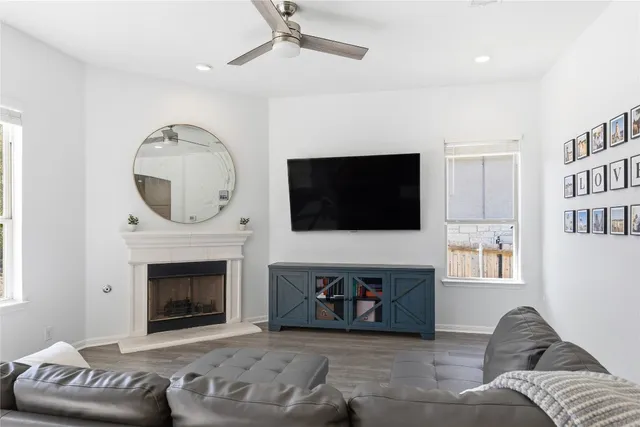 a living room with furniture a fireplace and a flat screen tv