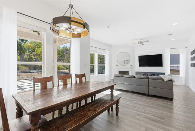 a kitchen with a refrigerator a stove and a wooden floor