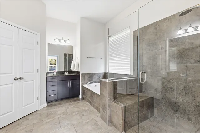 a spacious bathroom with a granite countertop bathtub shower and sink