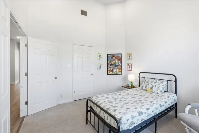 a bedroom with a bed and a large window