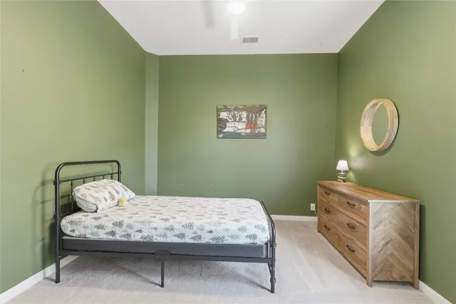 a bedroom with a bed and a dresser