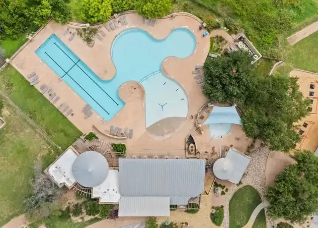 a balcony with wooden floor and outdoor seating