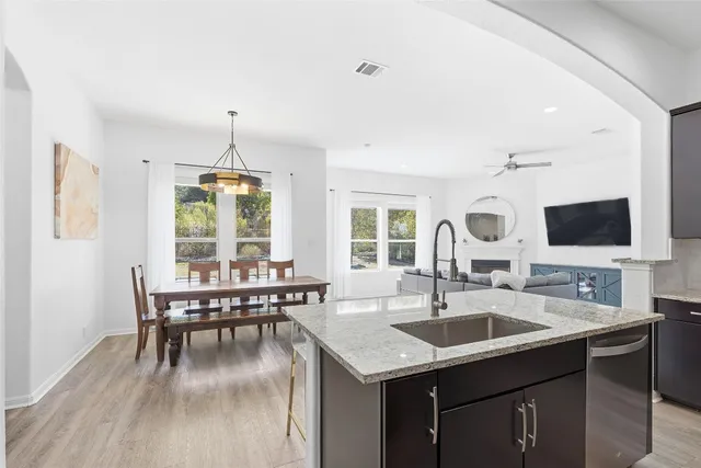 a kitchen with center island table and chairs in it