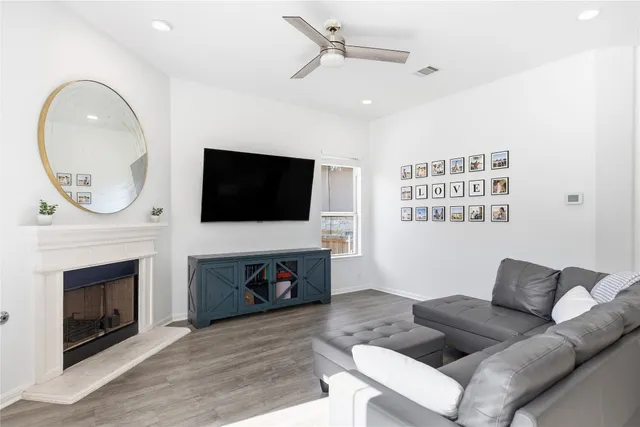 a living room with furniture a fireplace and a flat screen tv