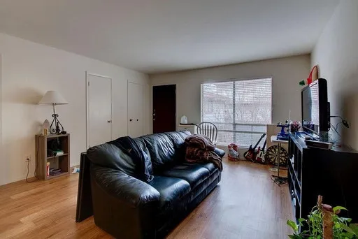 a living room with furniture window and wooden floor