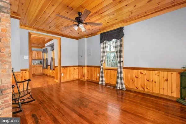 a kitchen with stainless steel appliances granite countertop a refrigerator oven a sink dishwasher and a stove with wooden floor