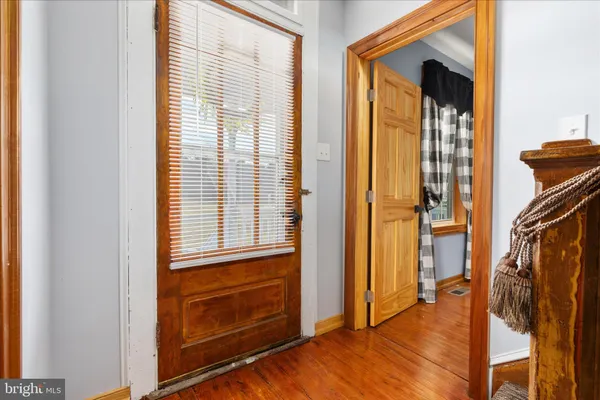 a view of an empty room with a chandelier fan