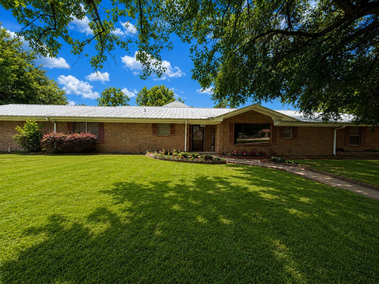 416 Division Street Jewett, TX 75846 - Photo 21 of 38 a front view of a house with garden