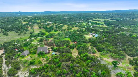 a view of a green field with lots of bushes
