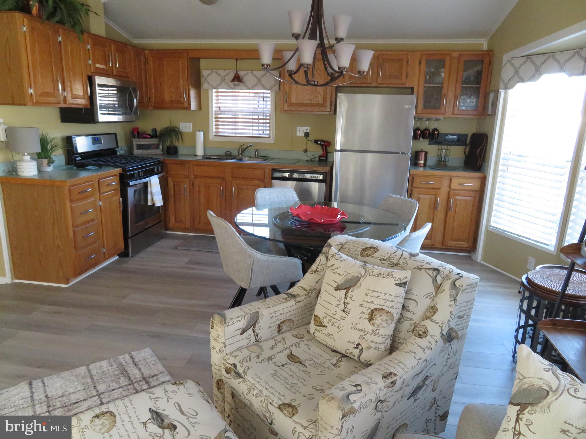 120 Skipjack Circle Berlin, MD 21811 - Photo 16 of 91 a kitchen with stainless steel appliances kitchen island granite countertop a refrigerator stove microwave and sink