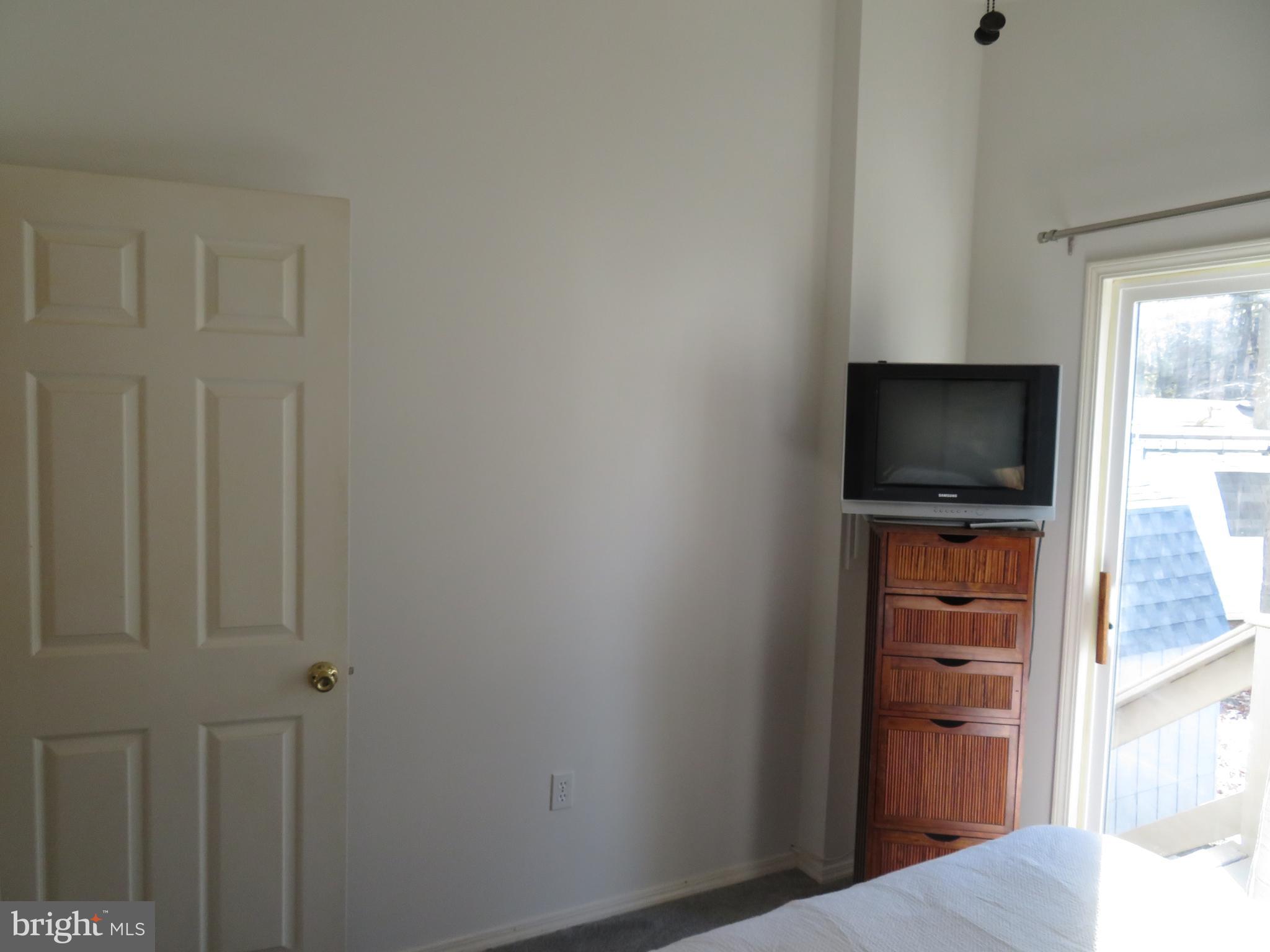 120 Skipjack Circle Berlin, MD 21811 - Photo 45 of 91 a view of a bedroom with a flat tv screen and dresser