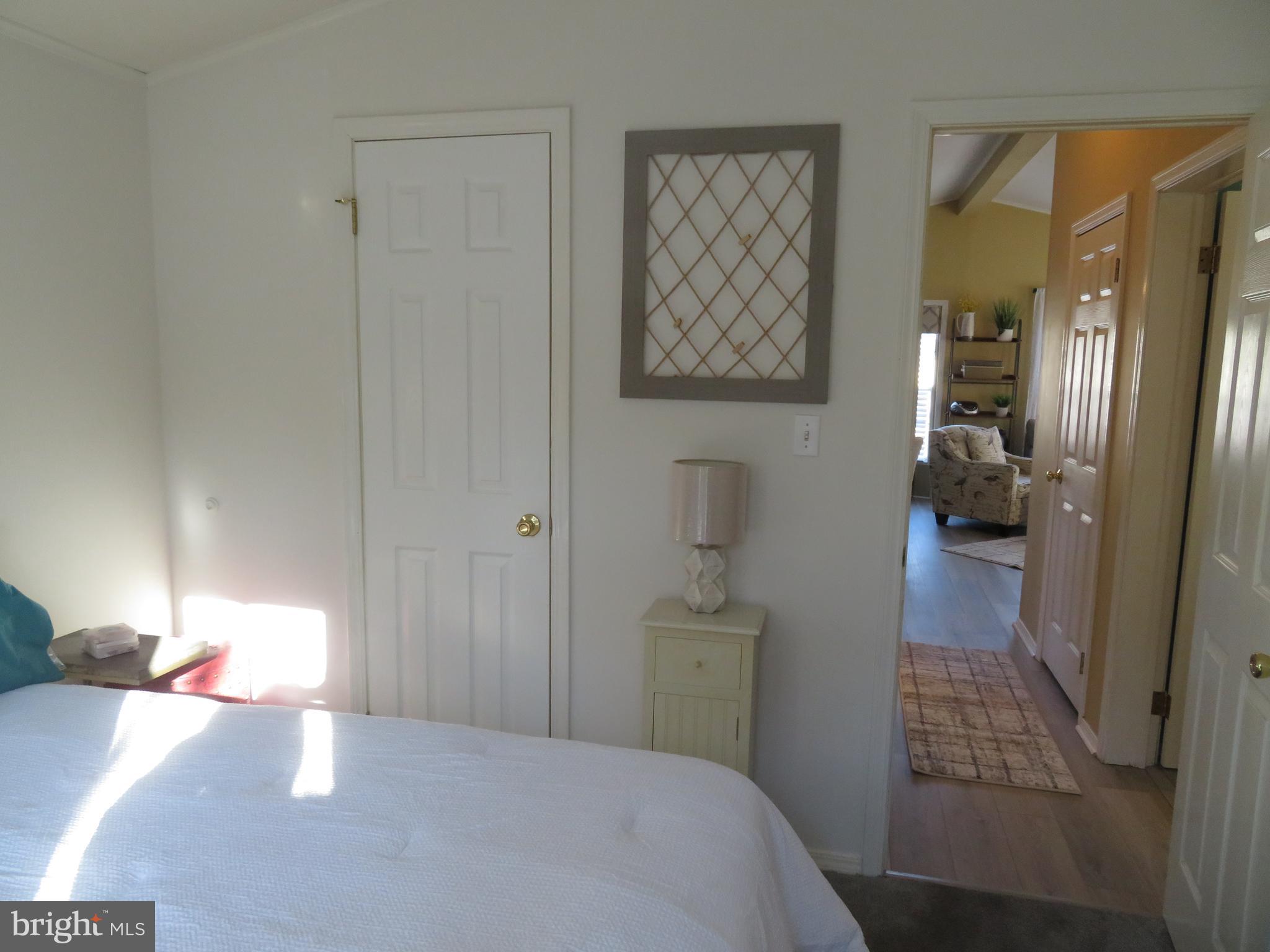 120 Skipjack Circle Berlin, MD 21811 - Photo 46 of 91 a bedroom with a bed and a lamp on dresser