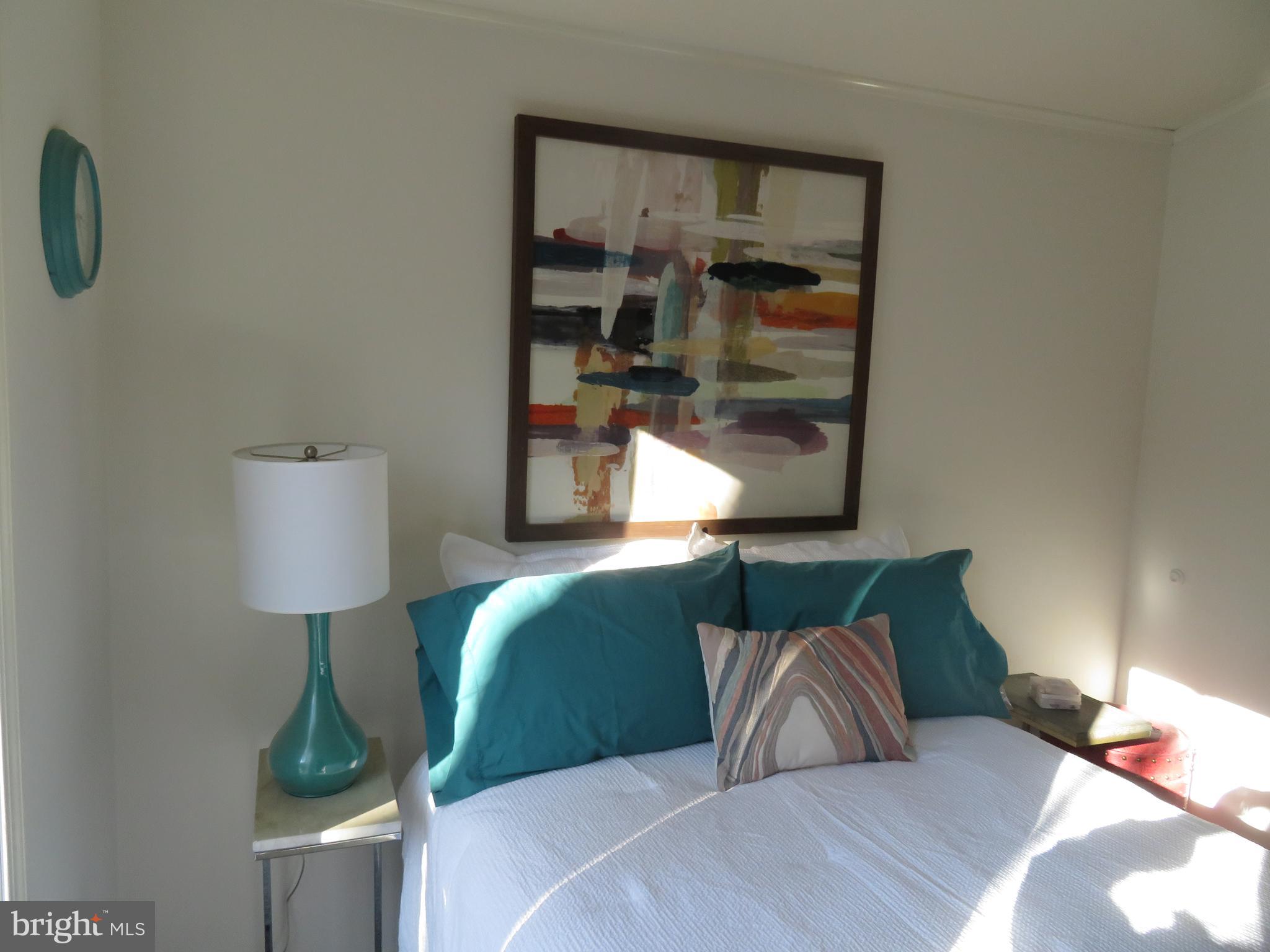 120 Skipjack Circle Berlin, MD 21811 - Photo 48 of 91 a bedroom with a bed and lamp