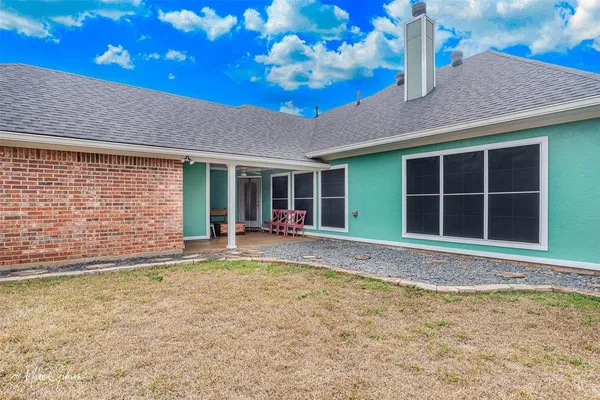 a view of a house with a backyard and porch