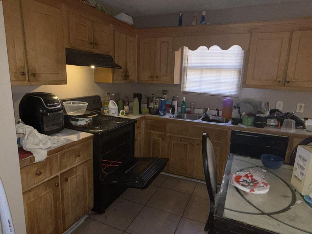 3462 Lawton Road Macon, GA 31204 - Photo 3 of 8 a kitchen with a sink a stove and cabinets