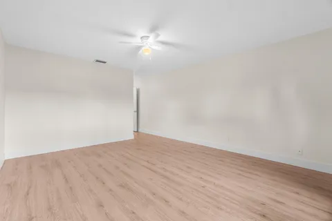 a view of an empty room with a fan