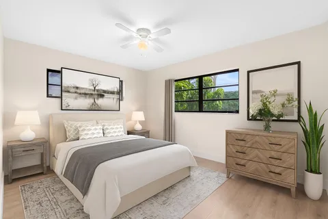 a bedroom with a large bed and a window