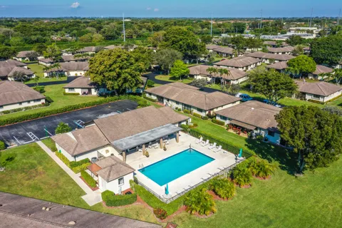 an aerial view of a house with swimming pool garden and patio