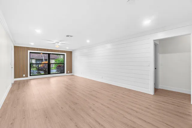 wooden floor in an empty room with a window