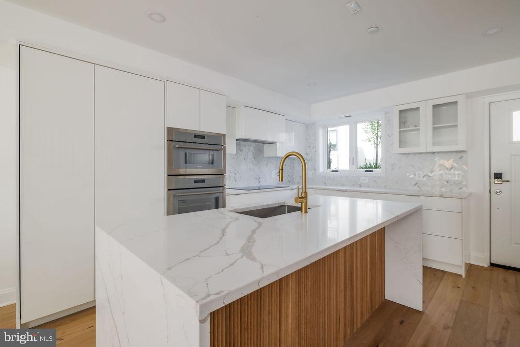1200 Eton Court Northwest Washington, DC 20007 - Photo 11 of 66 a kitchen with kitchen island a sink appliances and cabinets