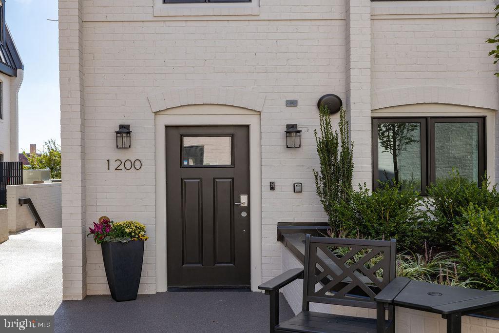 1200 Eton Court Northwest Washington, DC 20007 - Photo 2 of 66 a front view of a house with potted plants