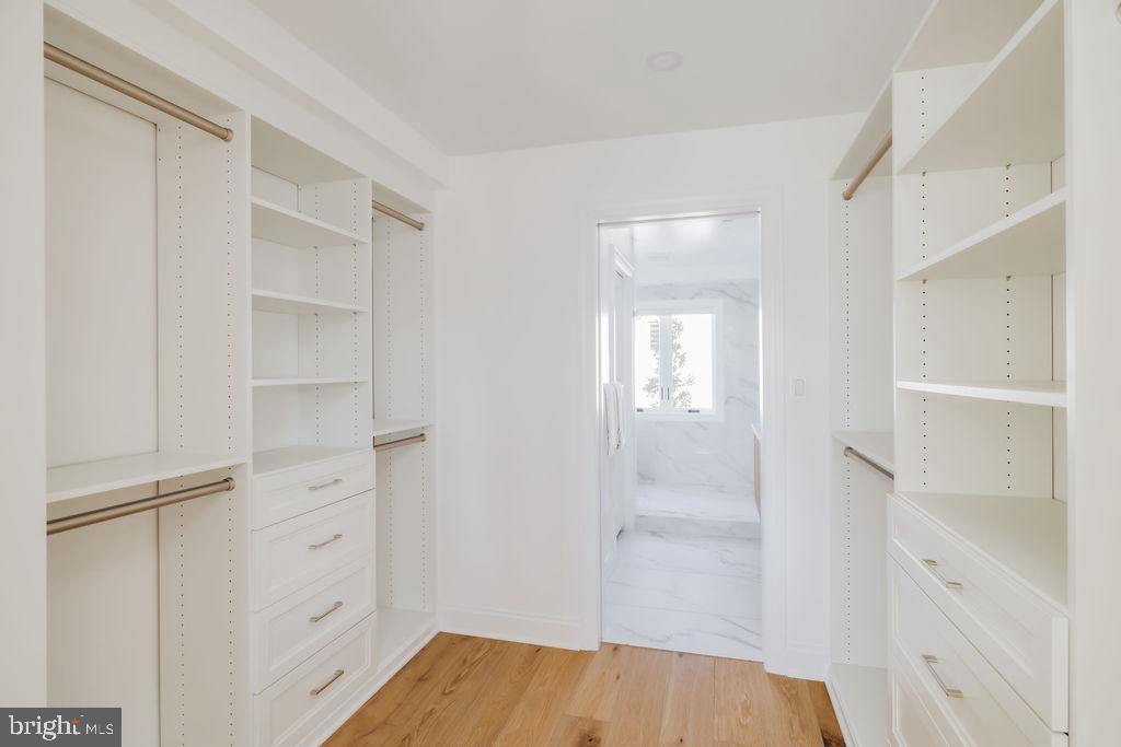 1200 Eton Court Northwest Washington, DC 20007 - Photo 34 of 66 a view of walk in closet with empty racks