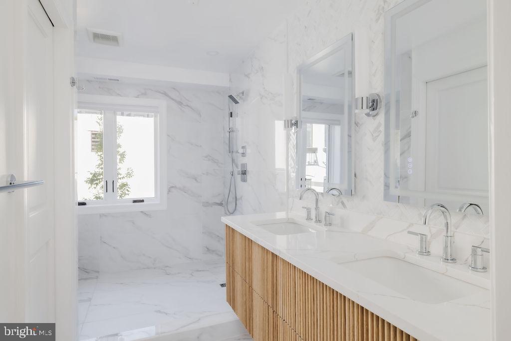 1200 Eton Court Northwest Washington, DC 20007 - Photo 36 of 66 a bathroom with double vanity and a mirror