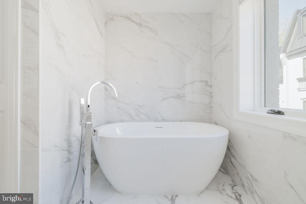 1200 Eton Court Northwest Washington, DC 20007 - Photo 40 of 66 a white bath tub sitting in a bathroom