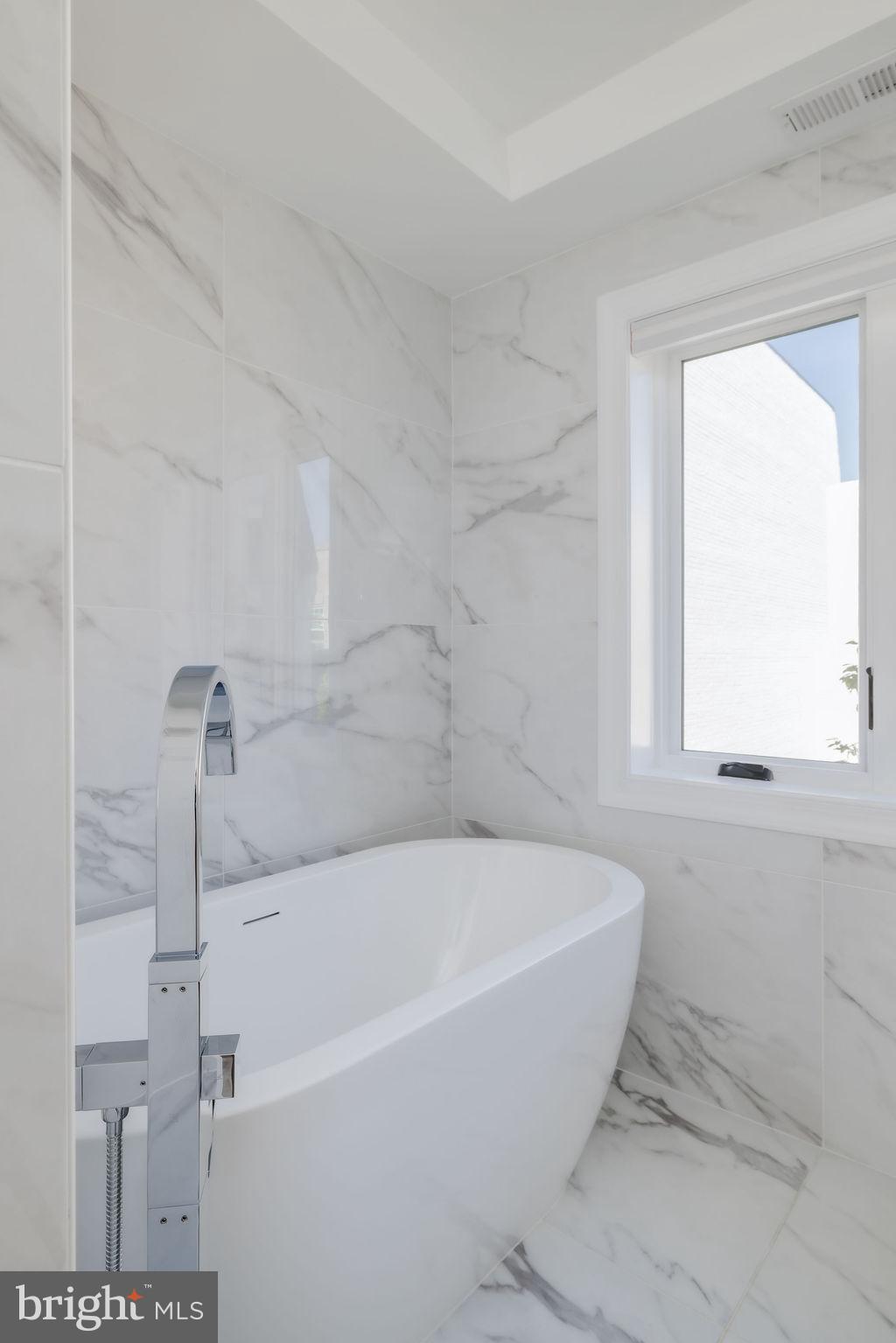 1200 Eton Court Northwest Washington, DC 20007 - Photo 43 of 66 a white bath tub sitting in a bathroom