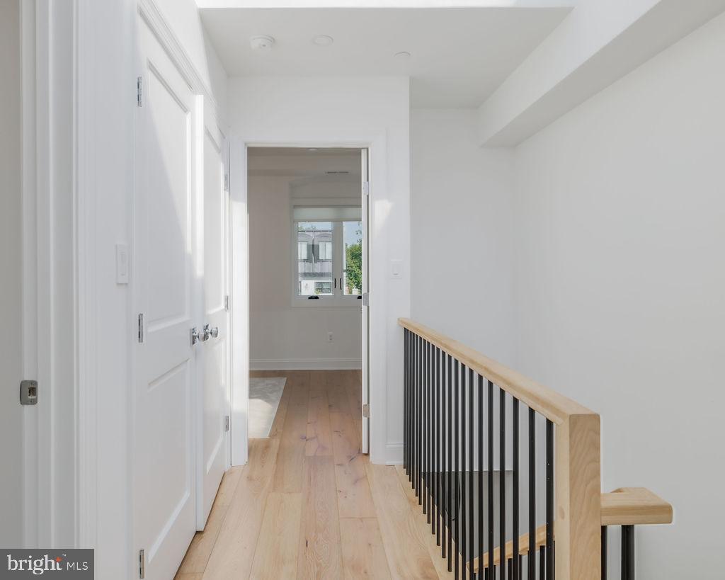 1200 Eton Court Northwest Washington, DC 20007 - Photo 54 of 66 a view of a hallway with wooden floor and a bathroom