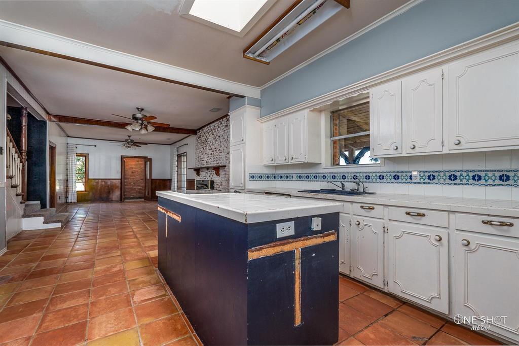 3741 Caldwell Road Abilene, TX 79601 - Photo 11 of 36 Kitchen with a center island, sink, white cabinetry, crown molding, and ceiling fan