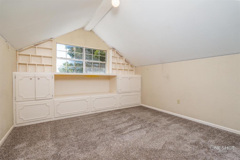 3741 Caldwell Road Abilene, TX 79601 - Photo 28 of 36 Additional living space featuring vaulted ceiling with beams, carpet, and built in features