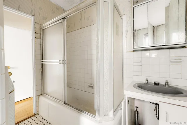 a bathroom with a sink and shower