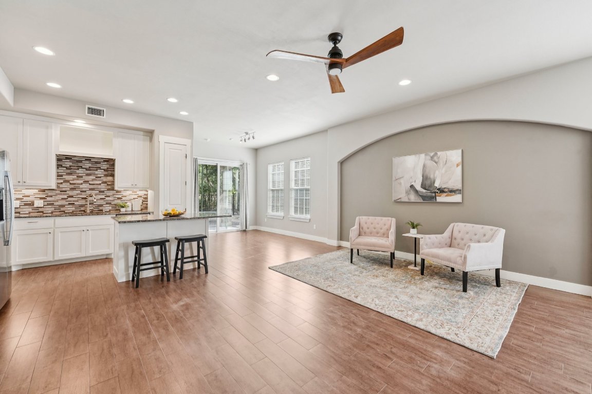 Designer lighting and wood-look tile floors add modern warmth to your living space.