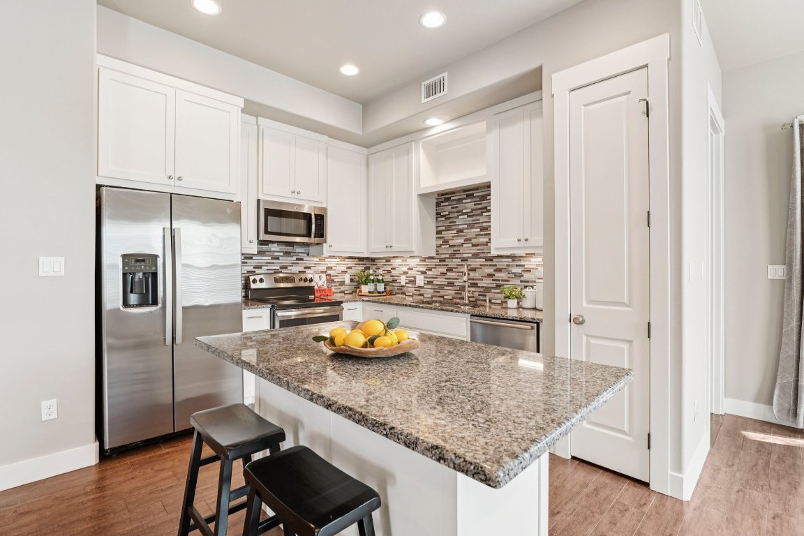 4301 Mansfield Dam Road, Unit 2101 Austin, TX 78734 - Photo 4 of 15 Modern meets functional — cook, connect, and entertain with ease in this sleek kitchen.