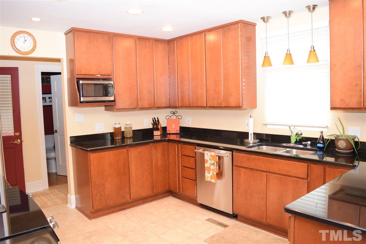 1987 Shotwell Road Clayton, NC 27520 - Photo 5 of 25 Kitchen has been updated with granite counters, pull-out drawers and lazy susan throughout.