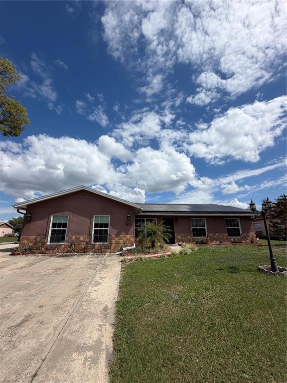 101 Gardenia Road Kissimmee, FL 34743 - Photo 1 of 24 a front view of house with yard and entertaining space