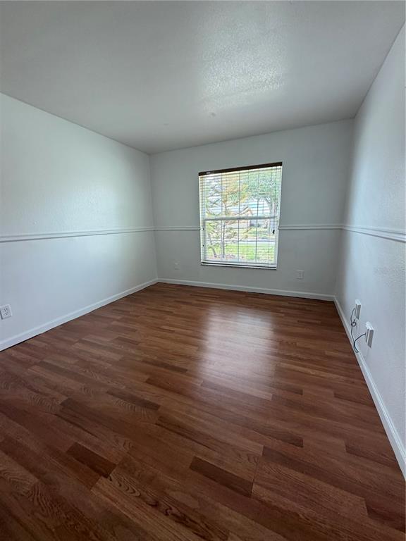 101 Gardenia Road Kissimmee, FL 34743 - Photo 11 of 24 an empty room with wooden floor and windows