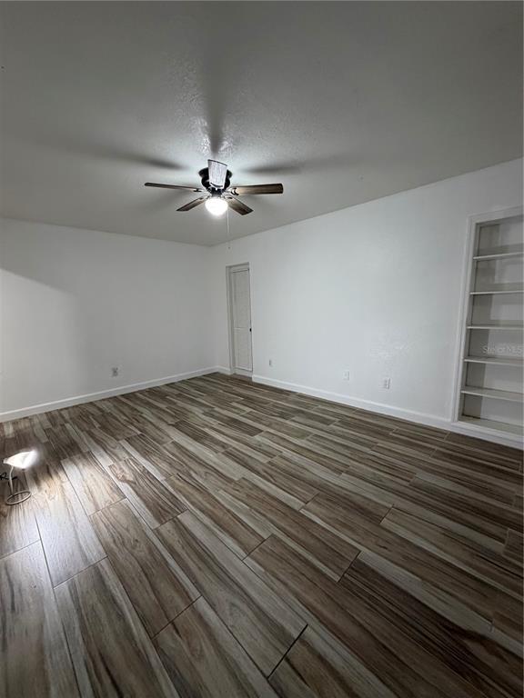 101 Gardenia Road Kissimmee, FL 34743 - Photo 16 of 24 a view of empty room with wooden floor and fan