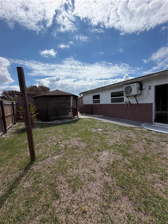 101 Gardenia Road Kissimmee, FL 34743 - Photo 21 of 24 a view of a backyard with table and chairs